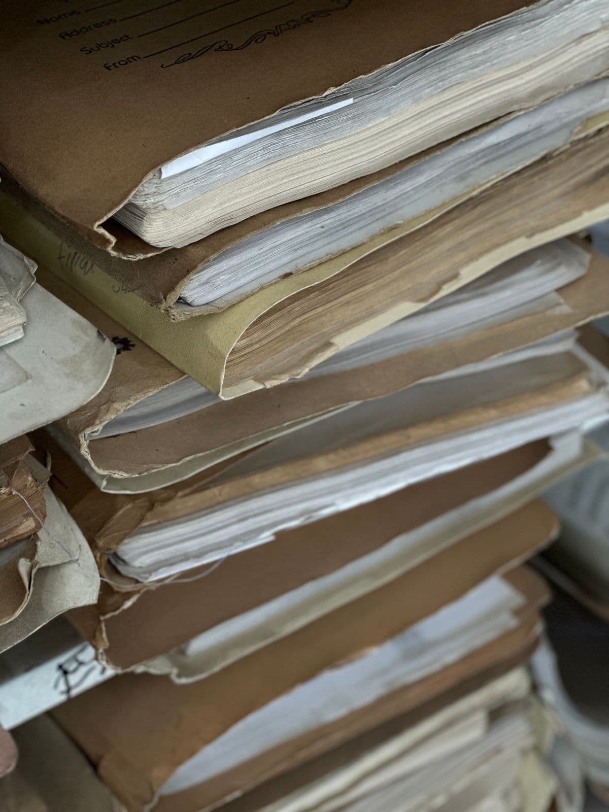 A stack of worn paper case files